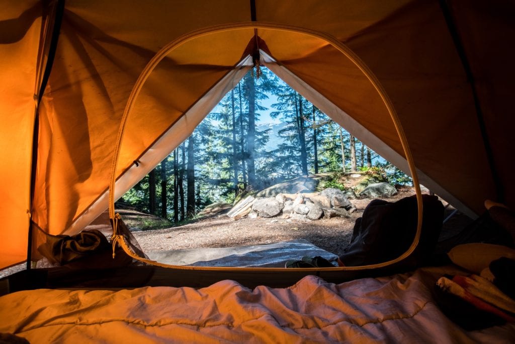 Tent pitched outdoors, essential camping trip gear