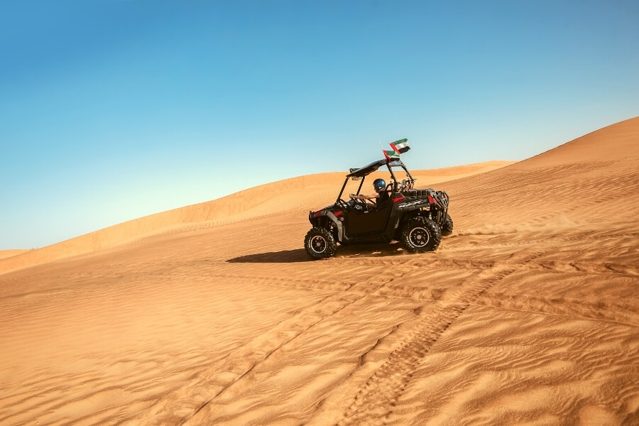 Riders on dune buggies in the Dubai desert