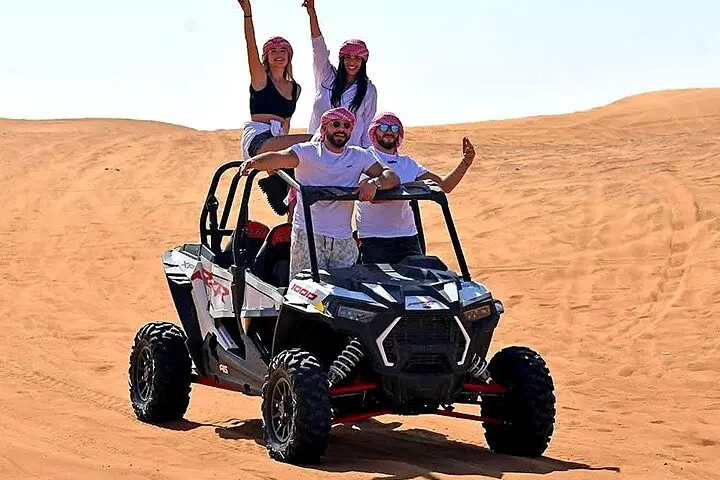 Dune buggy riding over sand dunes on a Dubai buggy adventure